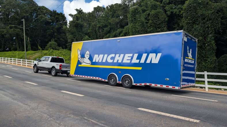 A Ford F-350 towing a race car trailer